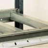 Galvanised Dexion HI280 crossbeam supporting a chipboard shelf level between shelf beams
