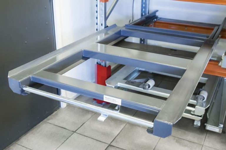 Beam-mounted EUR pallet pull-out unit fully extended in pallet racking