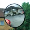 Round glass convex safety mirror showing a blind access ramp and parked vehicles