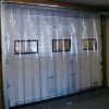 PVC strip curtains installed across an industrial warehouse doorway