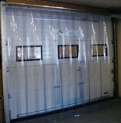 PVC strip curtains installed across an industrial warehouse doorway