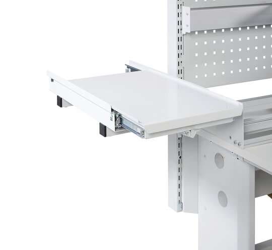 Light grey Treston pull-out printer shelf shown extended beside a workbench