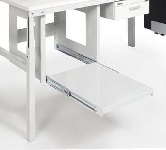 Empty Treston pull-out printer shelf extended beneath a packing bench