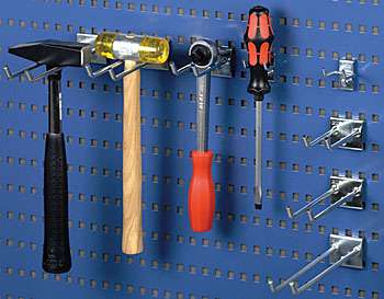 Hand tools hanging from hooks on a blue perforated tool panel