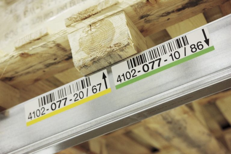 Barcode warehouse racking label strip with location code on a pallet rack beam