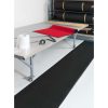 Black Wearbond anti-fatigue mat beside a work table in a dry industrial workspace
